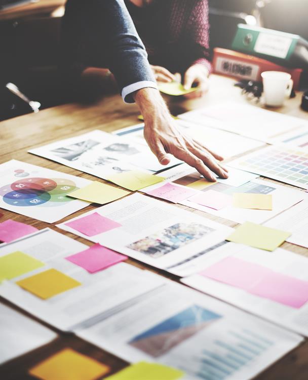 Photo of a person reviewing documents on a table
